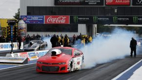 A Chevy does a burnout during a drag race.
