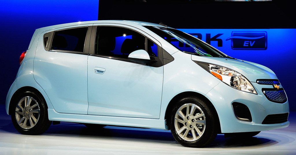 A Chevy Spark is under a blue spotlight on display in 2012.
