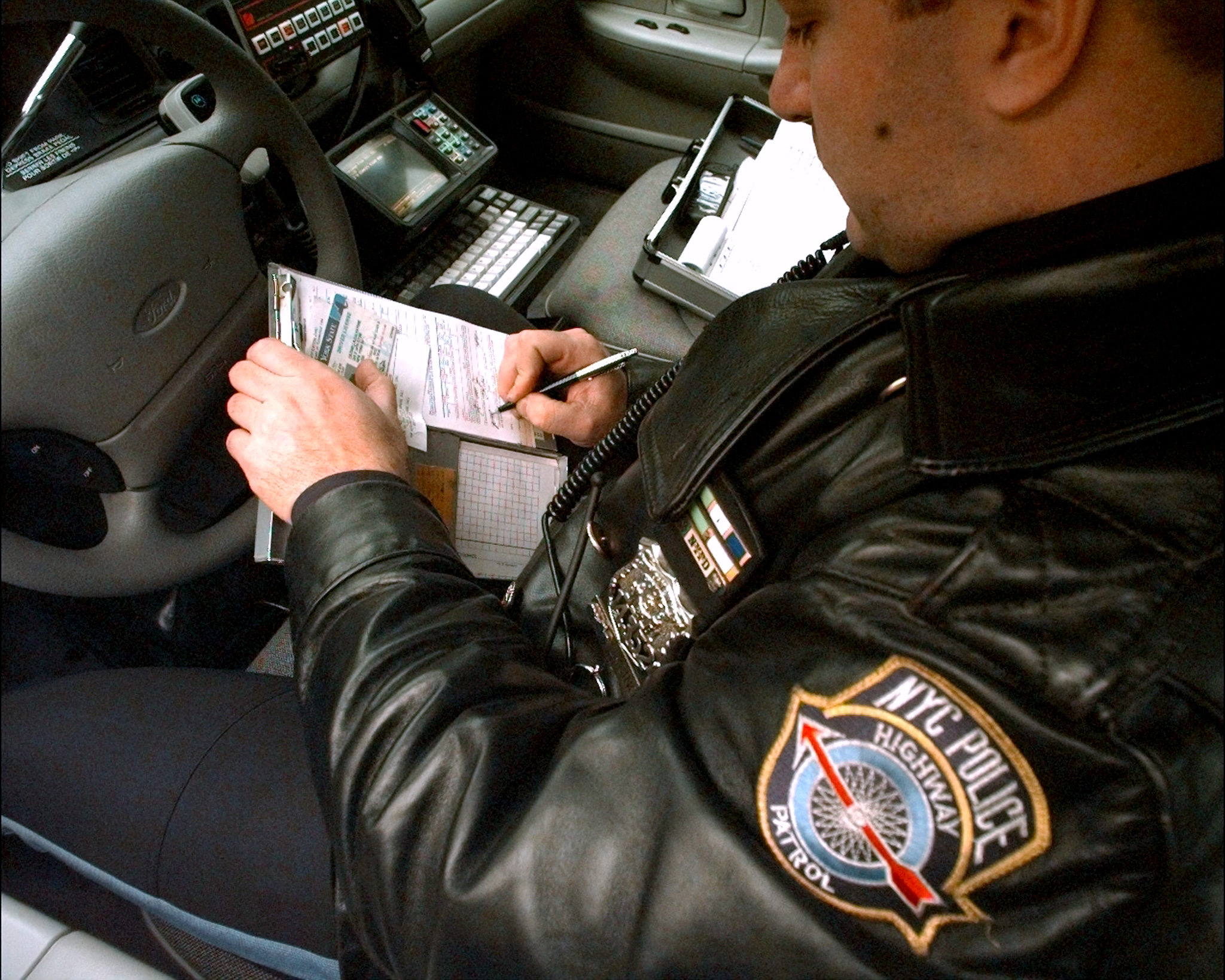 A police officer writes a ticket