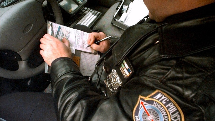 A police officer writes a ticket