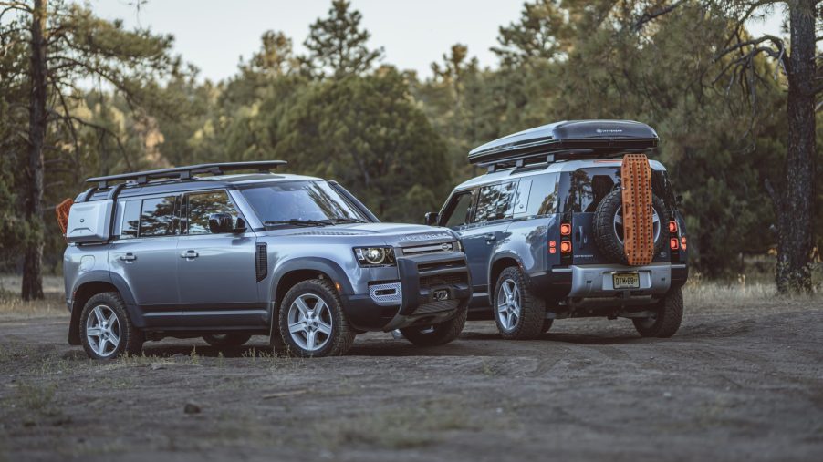 two 2021 Land Rover defenders parked in the dirt. These are the best midsize luxury SUV