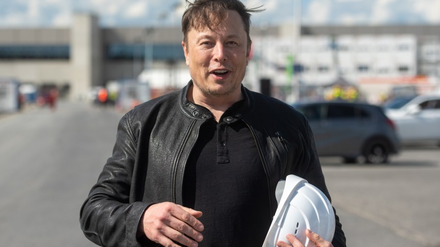 Tesla CEO Elon Musk holds a white hard hat as he stands on the construction site of the Tesla factory in Grünheide, Germany, on May 17, 2021
