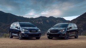 two 2021 Chrysler Pacifica models parked in the dirt in front of mountains