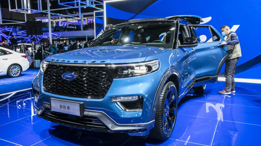 A blue 2021 Ford Explorer on a showroom floor.