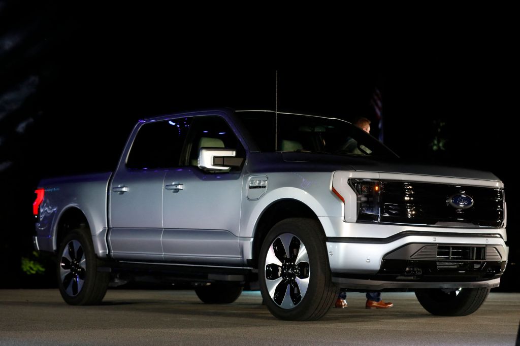 A Ford F-150 Lightning outside at night. Ford electric vehicles will be getting batteries from BlueOvalSK.