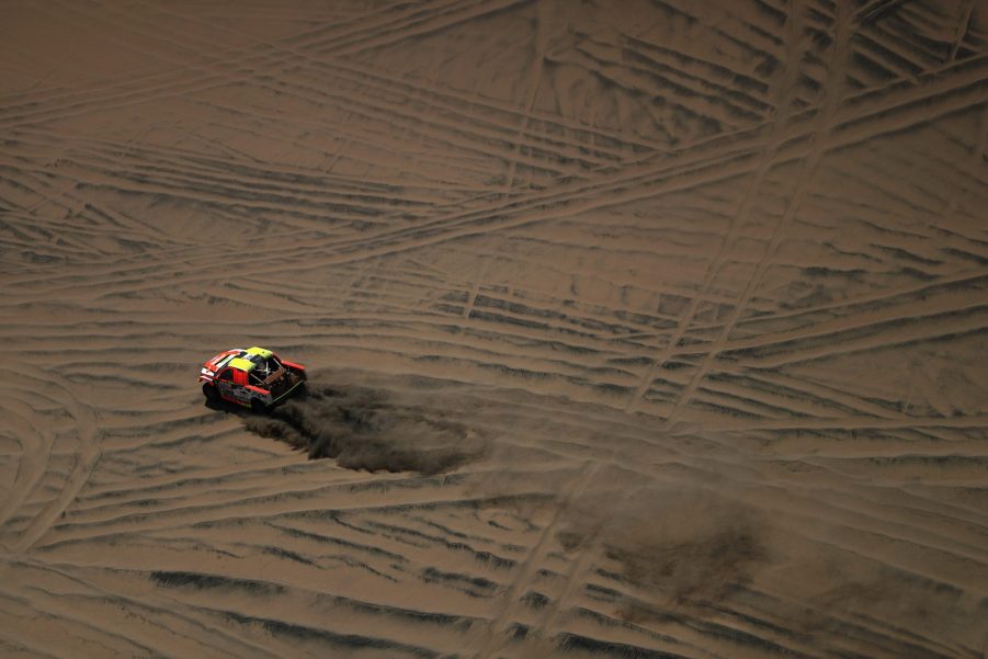 A Ford F-150 Raptor pickup truck in a desert rally