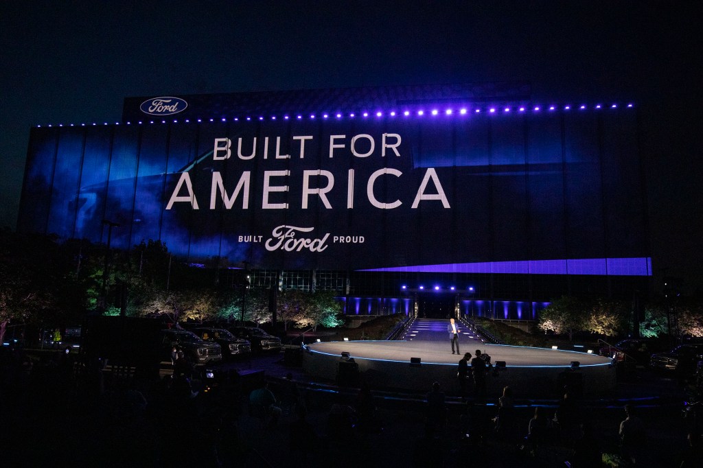 The Ford logo on stage at Ford World Headquarters as Ford announces new electric vehicle lineup.