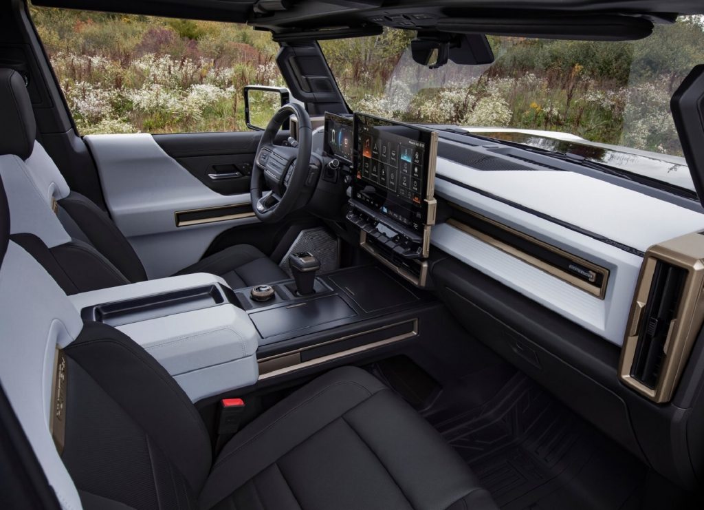 The white-and-black-leather front seats and dashboard of a GMC Hummer EV Truck Edition 1