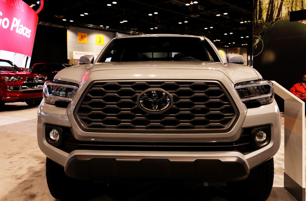 A 4x4 Toyota Tacoma on display at an auto show.