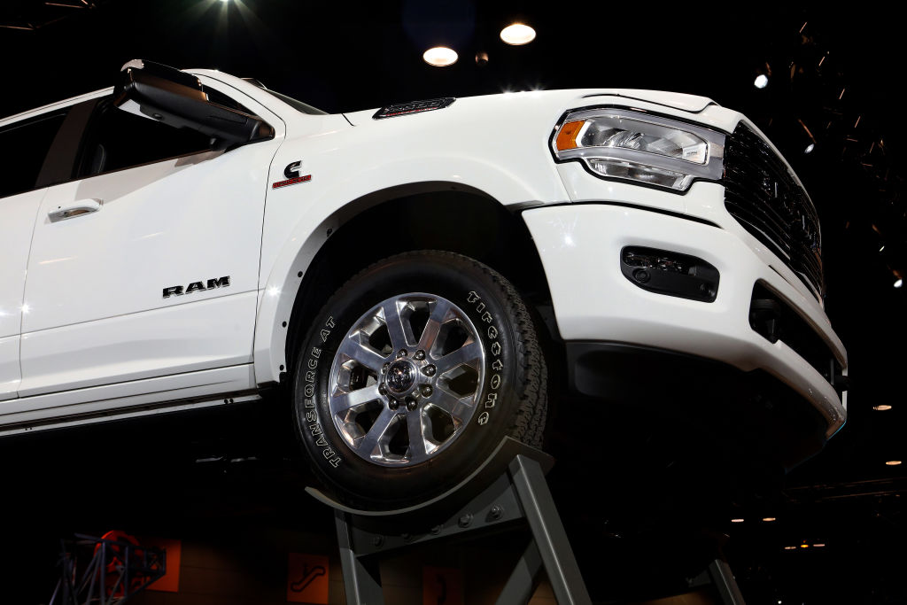 a white ram 1500 pickup truck on display at an auto show