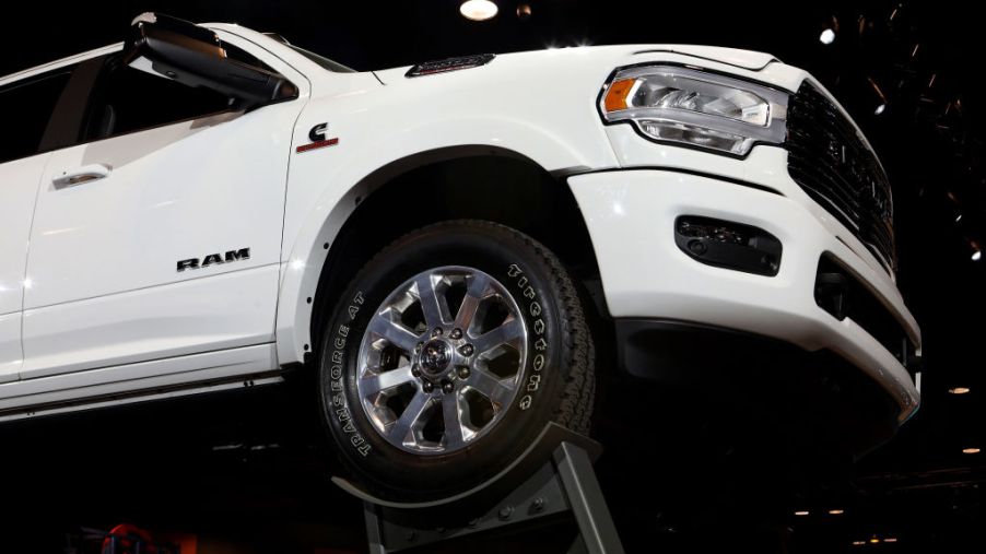 a white ram 1500 pickup truck on display at an auto show