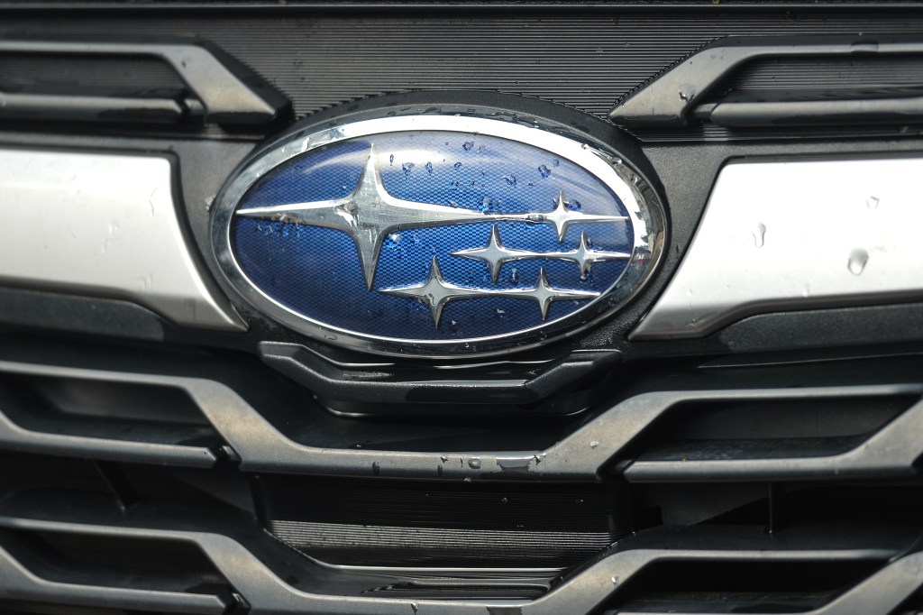 a subaru logo on a grille with water droplets 