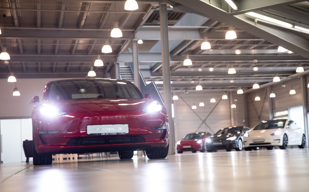 A red Model 3 indoors at a service center