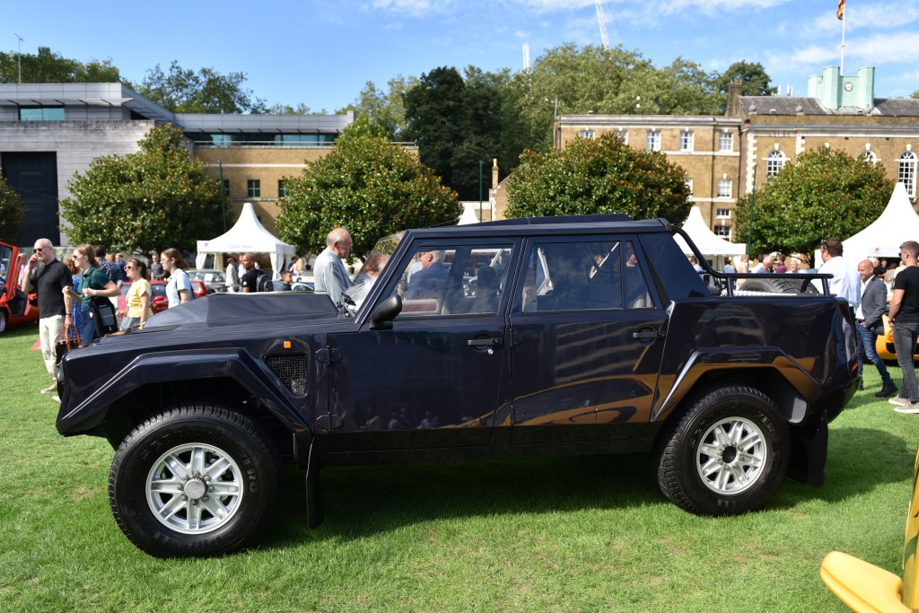 A 1990 Lamborghini LM002 4X4 parked on a lawn in black