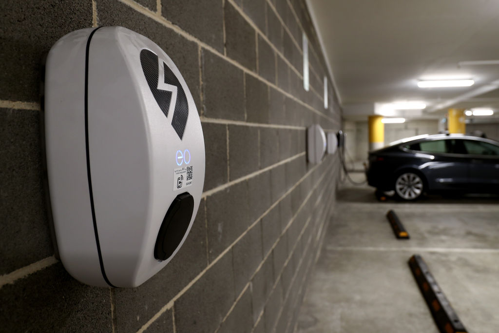 A grey Model Y charging in an underground parking garage