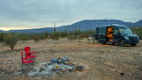 the camper van style of RV, which is among the most fuel-effcient RV models, parked at a scenic desert campsite