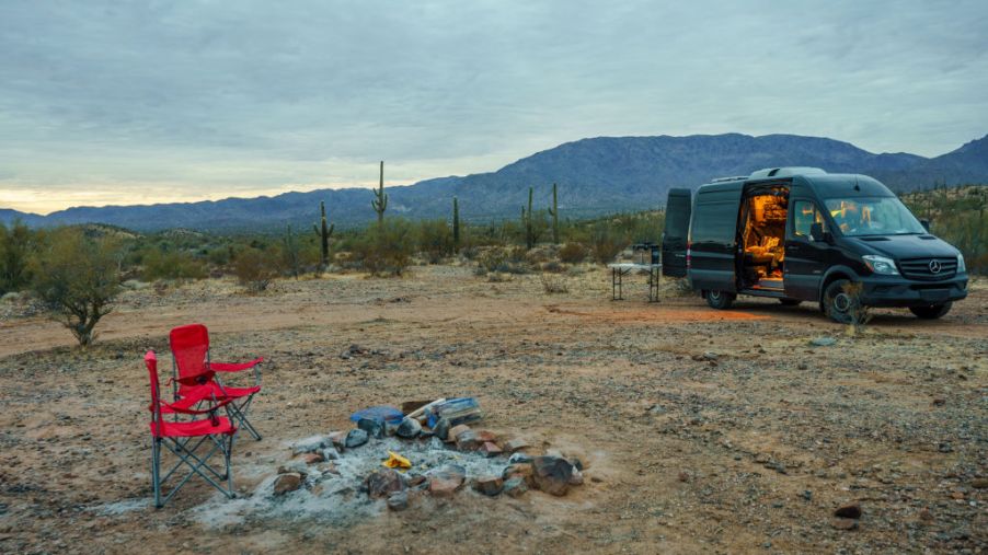 the camper van style of RV, which is among the most fuel-effcient RV models, parked at a scenic desert campsite