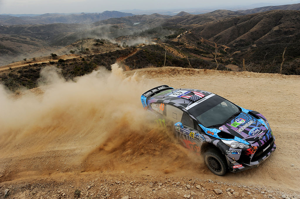 Ken Block drifts his Ford WRC car on a dirt road in Mexico