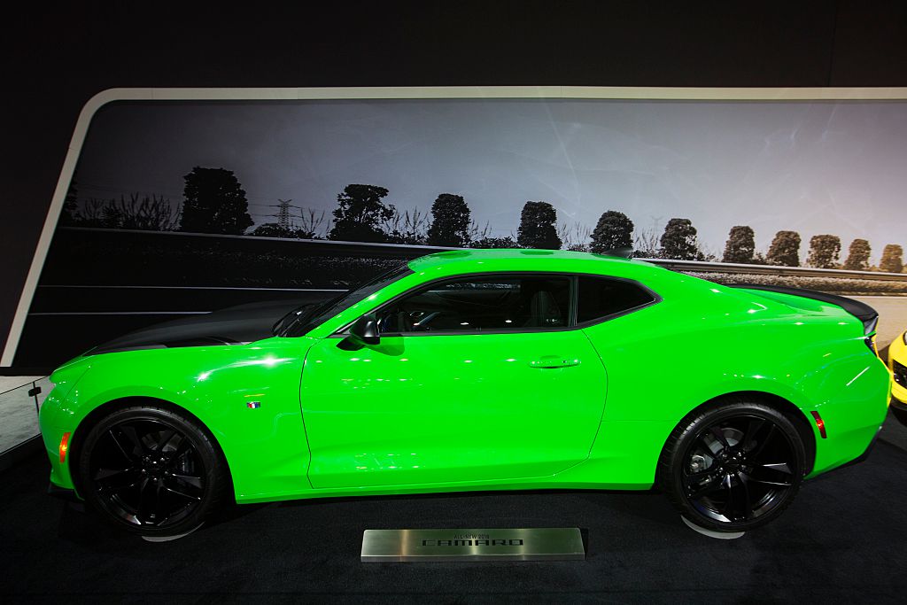 a green Chevrolet Camaro on display exemplifies a car with some of the best resale value around 