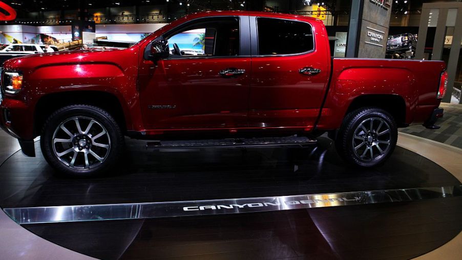 a red GMC Canyon at an auto show on display