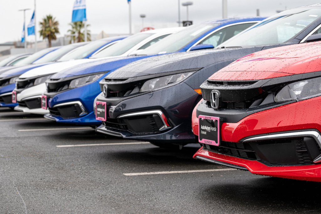 A lineup of Honda models parked at a dealership