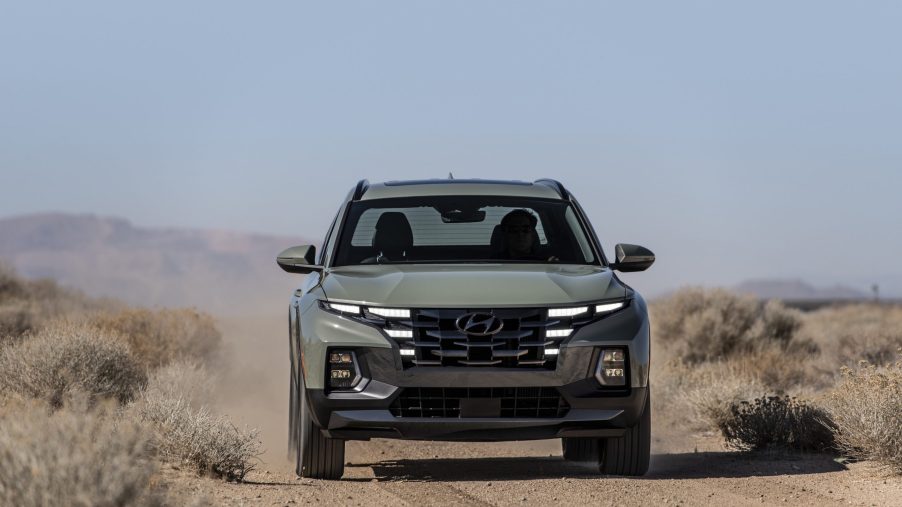 The gray 2022 Hyundai Santa Cruz driving in the desert.