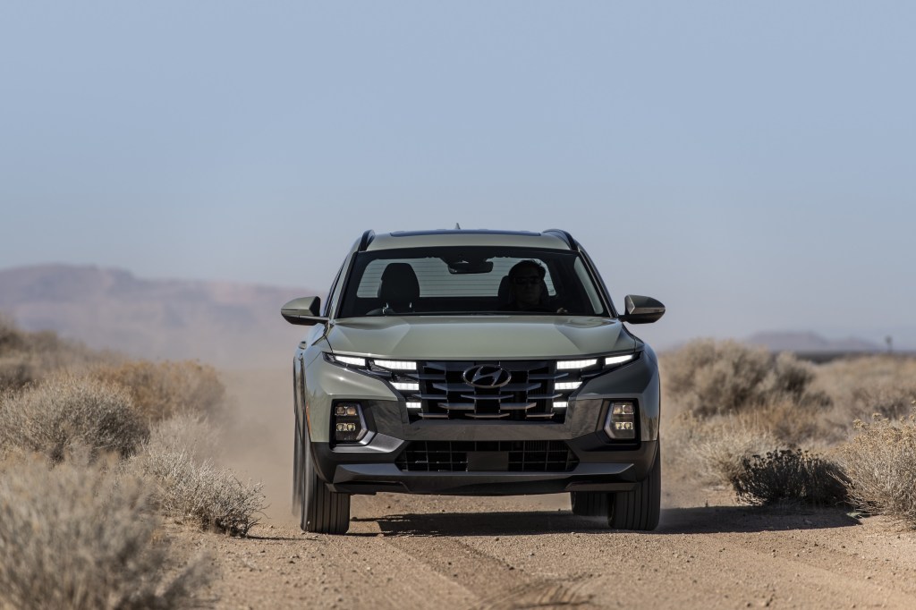 The gray 2022 Hyundai Santa Cruz driving in the desert.