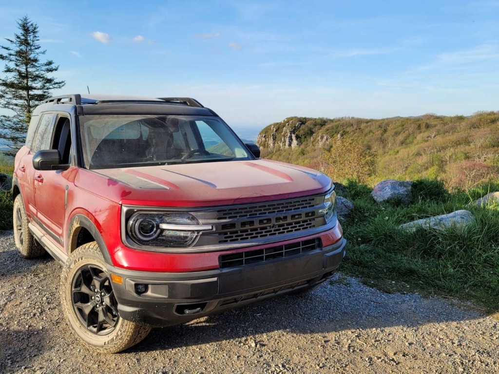 A red 2021 Ford Bronco Sport parked in front of a mountain view