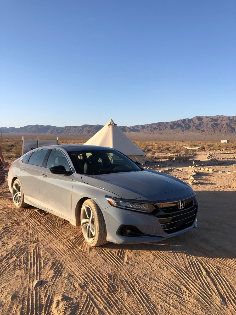 2021 Honda Accord Sport 2.0T parked in front of a tent in the desert. The 2021 Honda accord review proved to be a real winner.