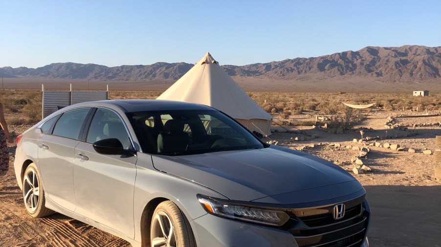 2021 Honda Accord Sport 2.0T parked in front of a tent in the desert. The 2021 Honda accord review proved to be a real winner.