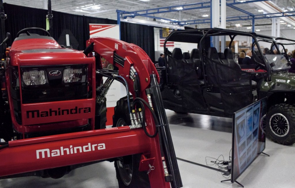 a red Mahindra tractor model on display 