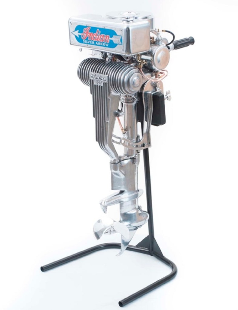 A silver-and-blue Indian Silver Arrow outboard boat motor on its stand