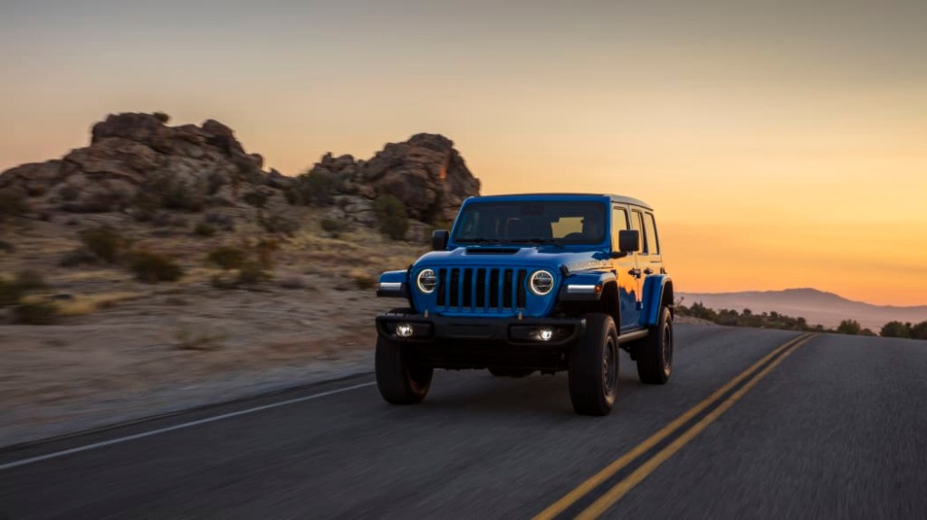  a Rubicon 392 Jeep Wrangler driving on a scenic two way highway in the desert