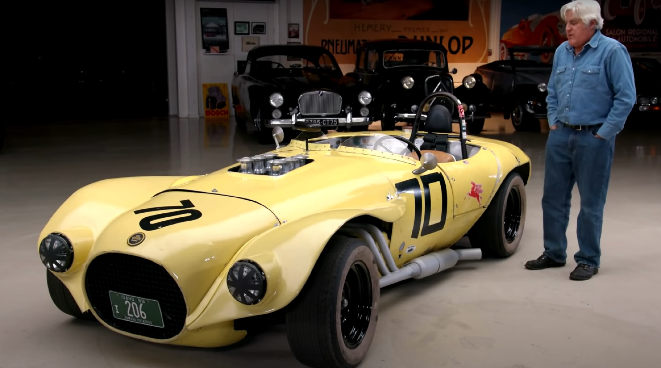 Jay Leno with the yellow 1959 Old Yeller II in his garage