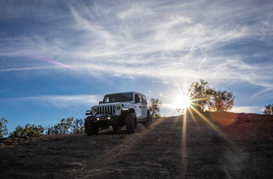A Jeep Wrangler off-roading, the Jeep Wrangler is among the best used SUVs for camping