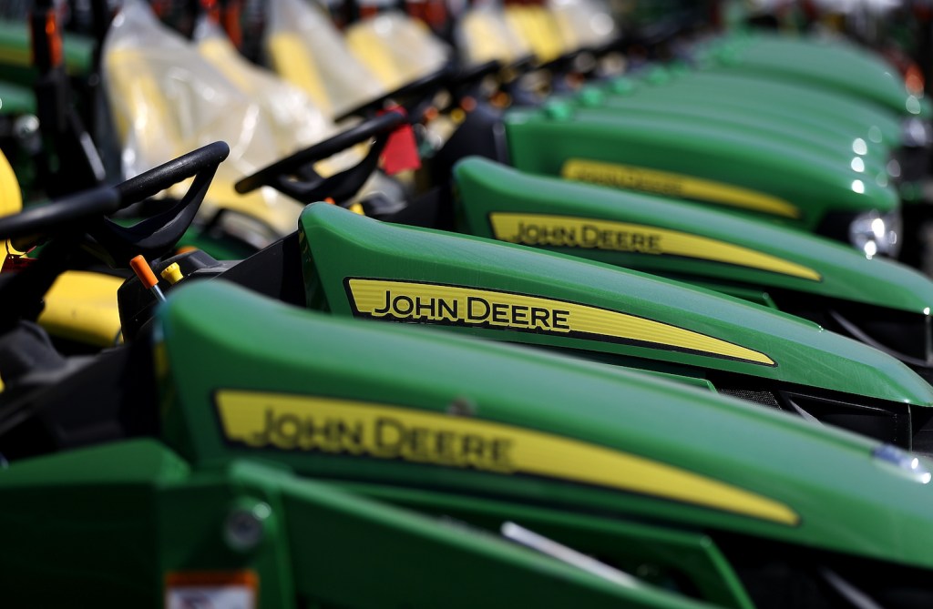 John Deere riding lawn mowers in front of a store