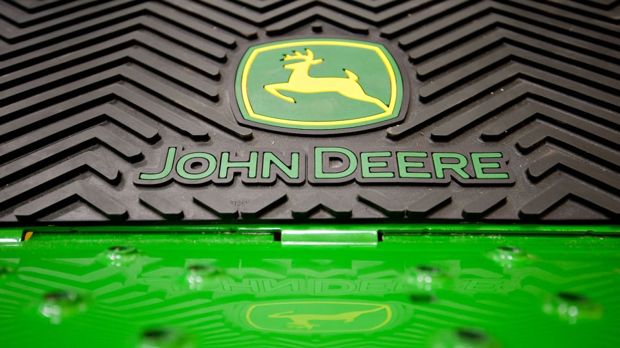 The John Deere logo on a riding lawn mower