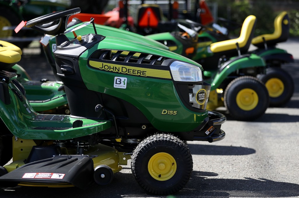 A lineup of John Deere riding lawn mowers, John Deere is one of the most reliable lawn mower brands