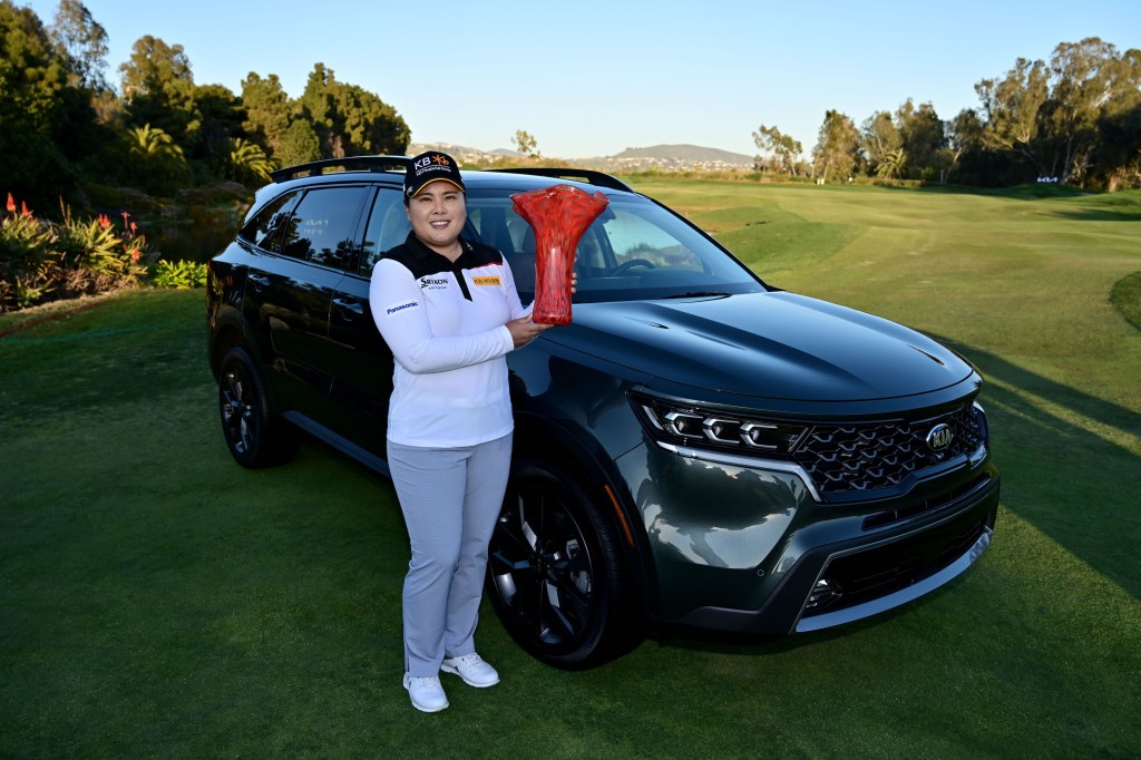 Inbee Park of South Korea poses with the winner’s trophy and her black 2021 Kia Sorento after her -14 under par victory during the Final Round of the KIA Classic at the Aviara Golf Club