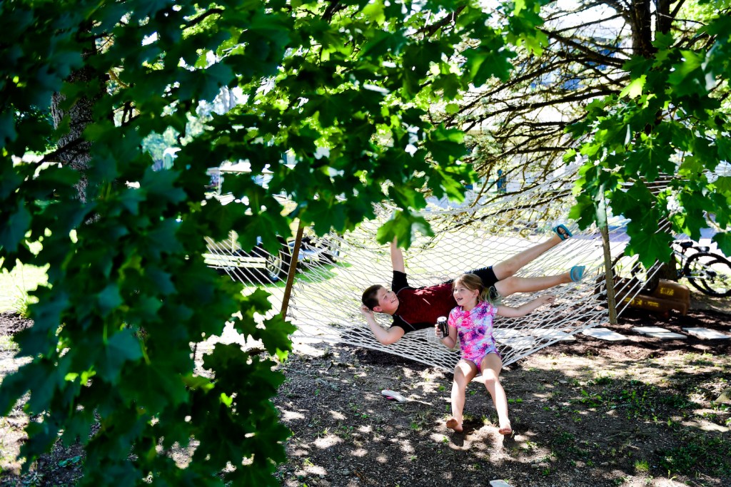 Kids relaxing in a hammock, a good downtime activity when RVing with kids.