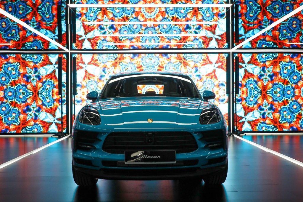 A baby blue Porsche Macan in a stained glass photobooth at it's release in Seoul.