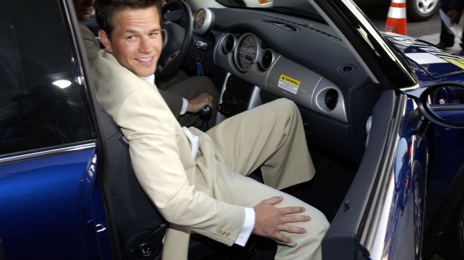 Actor Mark Wahlberg sits in a blue car outside Grauman's Chinese Theatre in Hollywood, California, during the world premiere of the film 'The Italian Job'