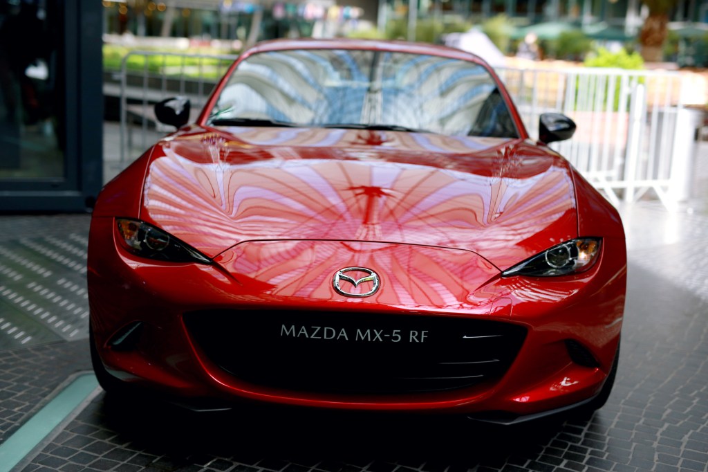 The roof of the Sony Center reflects on the bonnet of the red Mazda MX-5 RF during the Mazda Spring Cocktail at Sony Centre