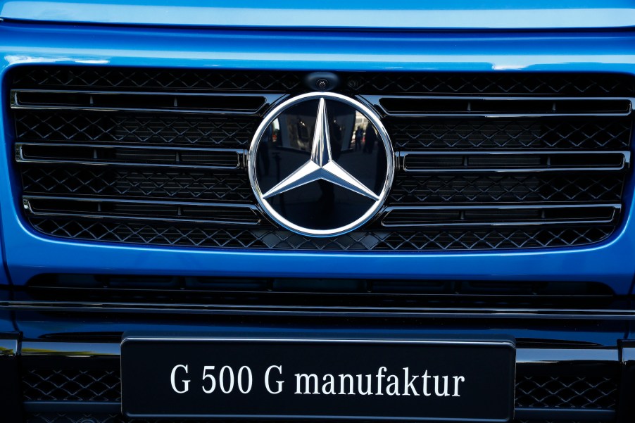 A silver Mercedes-Benz badge sits on the front grille of a blue Mercedes G-Class, AKA G-Wagon, outside the Daimler AG exhibition hall on day two of the IAA Frankfurt Motor Show in Frankfurt, Germany, on Wednesday, Sept. 11, 2019
