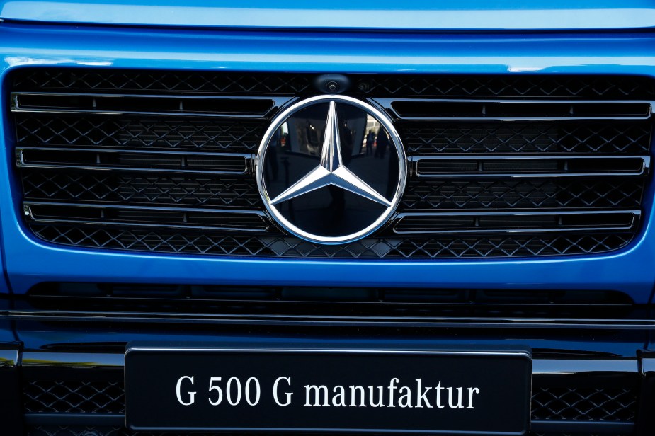 A silver Mercedes-Benz badge sits on the front grille of a blue Mercedes G-Class, AKA G-Wagon, outside the Daimler AG exhibition hall on day two of the IAA Frankfurt Motor Show in Frankfurt, Germany, on Wednesday, Sept. 11, 2019