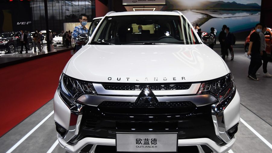 A white Mitsubishi Outlander car is displayed during the 19th Shanghai International Automobile Industry Exhibition