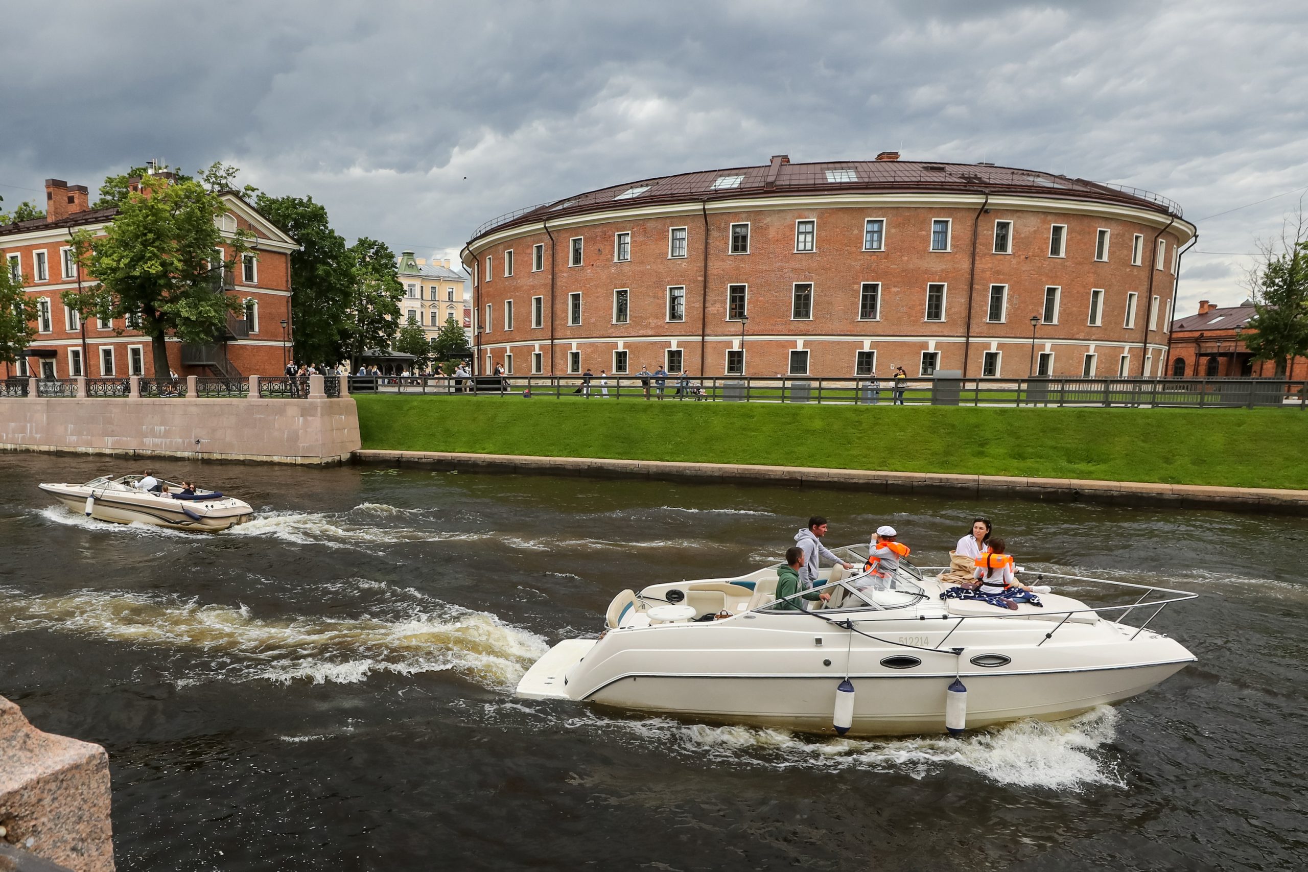 Motor boats go along the Admiralteisky Canal by St Petersburg's New Holland Island