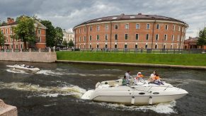 Motor boats go along the Admiralteisky Canal by St Petersburg's New Holland Island