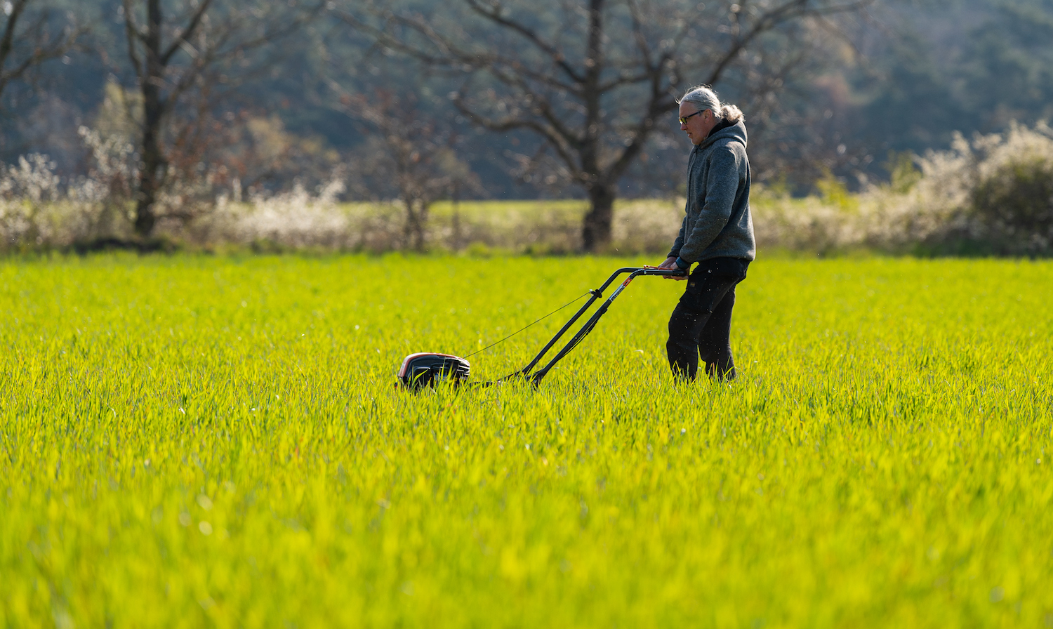A person showing using a lawn mower for big yards