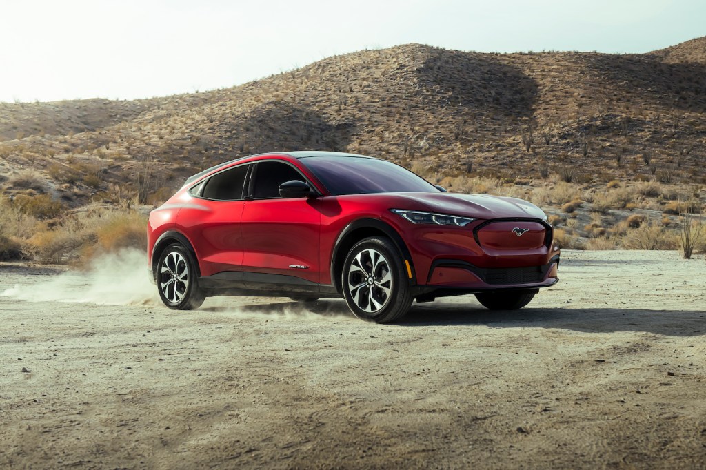 2021 Ford Mustang Mach-E driving down a dusty road